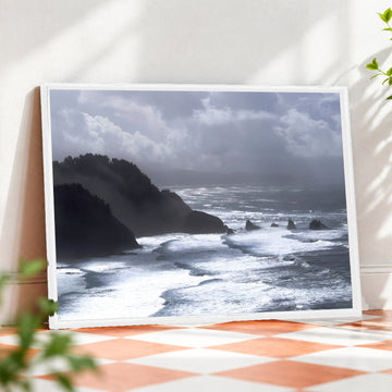 Framed ocean wall art featuring a coastal seascape photograph by Humans Among Us, displayed in a white frame for home decor.